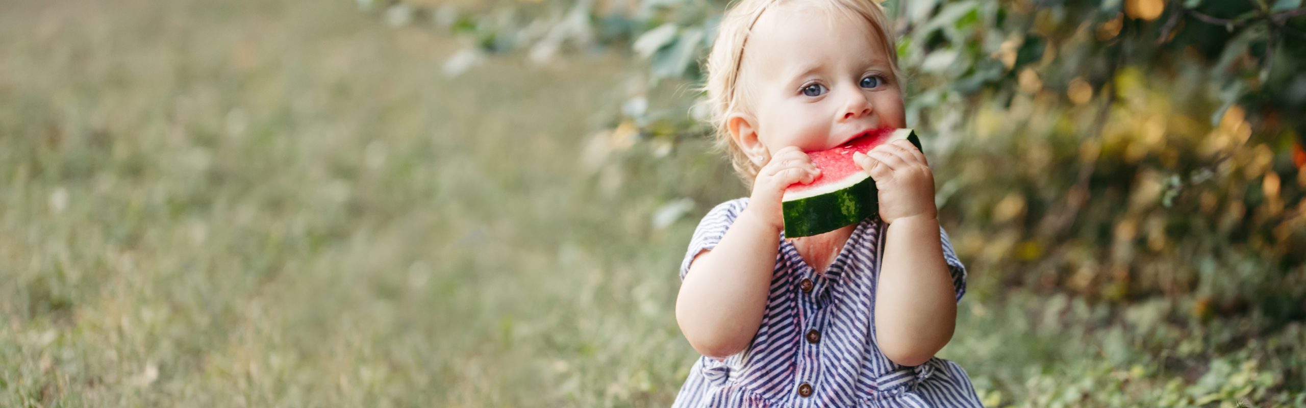 a kid eating watermelon